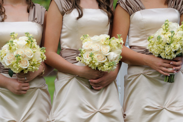 Three bridesmaids with bouquets