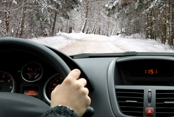 Woman driving car in winter