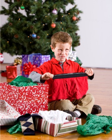 boy unwrapping underwear scowl