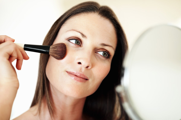 Woman applying makeup